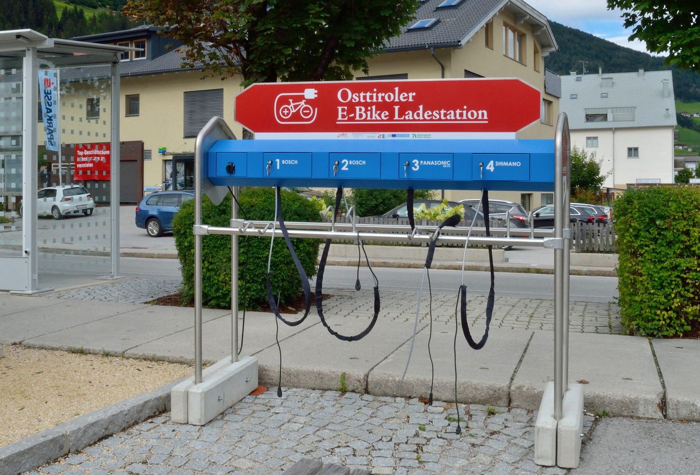 E-bike batteries charging at an outdoor charging station