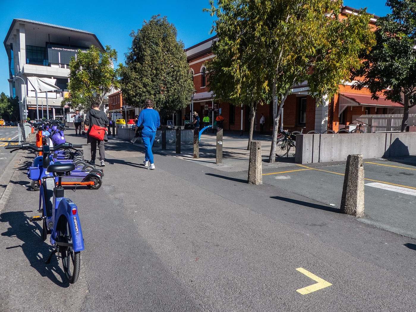 E-scooters and e-bikes parked outside South Brisbane railway station